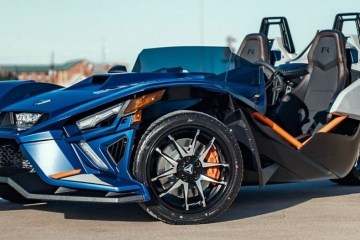 a motorcycle parked in front of a blue car